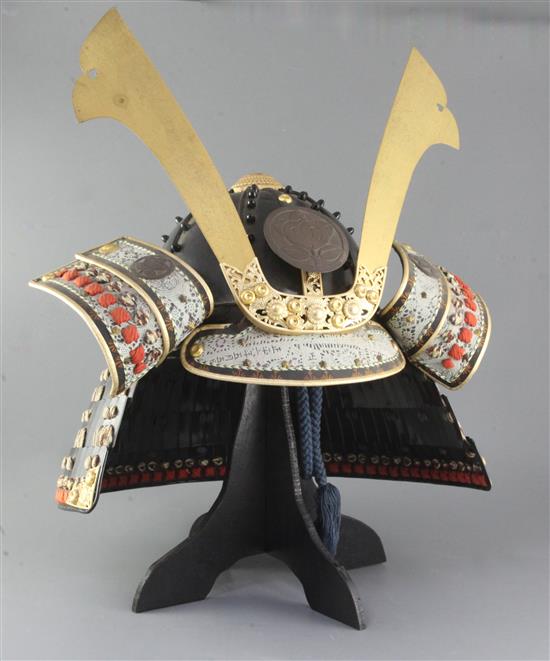 Japanese movie interest: A reproduction of a Japanese Samurai helmet (Kabuto), with ebonised box, helmet approximately 41.5cm wide